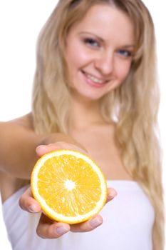 smiling young haelthy woman holding the orange in her hand