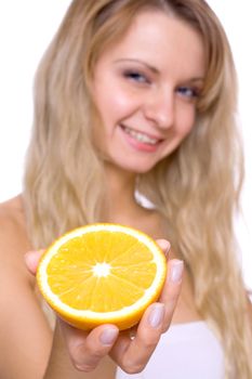 smiling young haelthy woman holding the orange in her hand