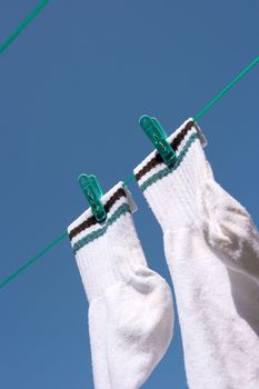 Drying socks hanging on the rope under clear blue sky