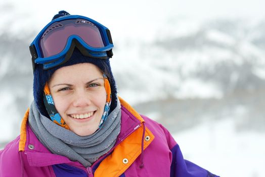 Portrait of a young, smiling female skier