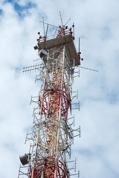 Old transmitter tower against blue, cloudy sky