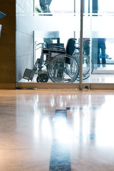 A wheelchair in a reception area of a hotel or hospital