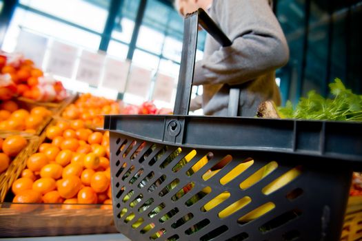 A detail of a man shopping for fruits and vegetables