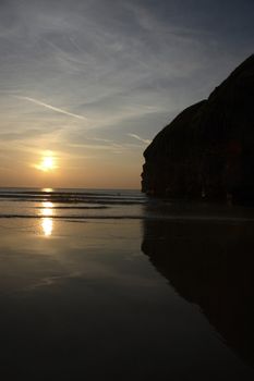 lone surfer against irish cliffs