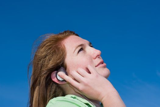 A young attractive model listening to music
