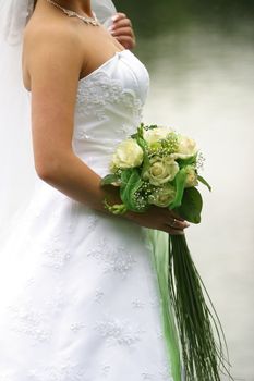 The bride holds a wedding bouquet