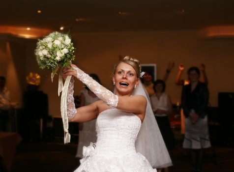 The bride throws a wedding bouquet to the girlfriends