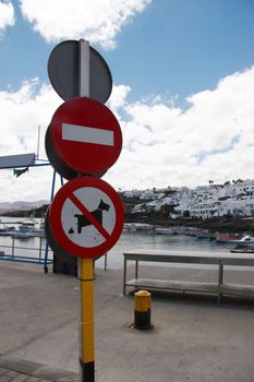 sign posts overlooking an old lanzarote harbour