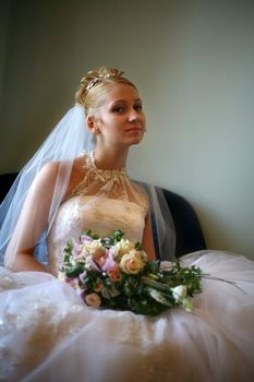 Portrait of the beautiful bride with a bouquet