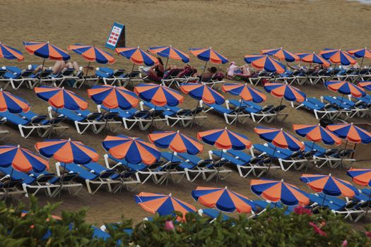 deck chairs on a sandy beach