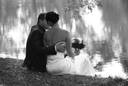 Recently married pair on a coast of lake