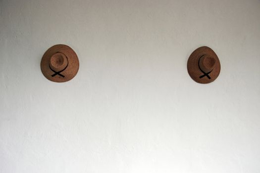 two local hats on a retaurant wall