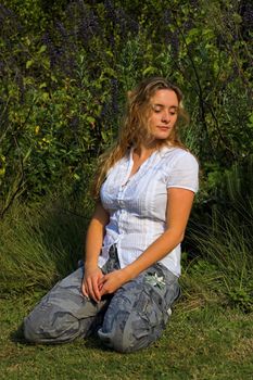 Attractive girl looking down and left in the garden