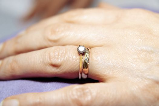 a female hand with wedding rings close up