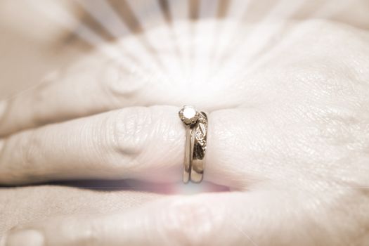 a female hand with wedding rings sparkling in close up