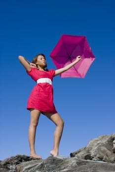 Girl in bright pink dress with bright pink umbrella
