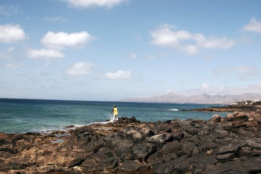 a view of a man fishing in lanzarote