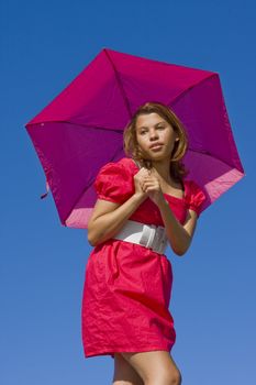 Girl in pink with bright pink umbrella