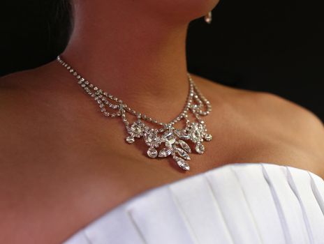 Wedding diamond necklace on a neck of the bride