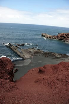 the coast line of a volcanic island