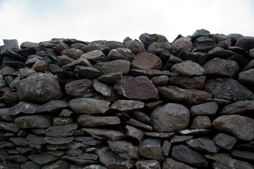 an old irish dry stone wall against a sky background