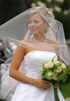 Portrait of the beautiful bride with a bouquet
