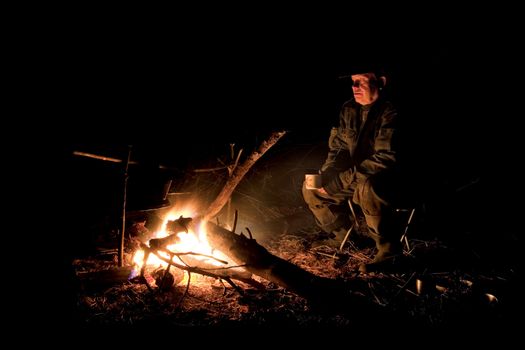 The hunter has a rest at a bonfire