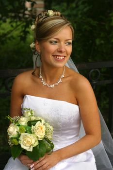 Portrait of the beautiful bride with a bouquet