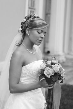 The beautiful bride with a bouquet from roses. b/w