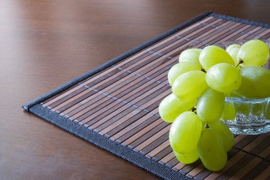 Juicy green grape on a bamboo napkin