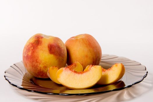 Slices of juicy peaches on white background
