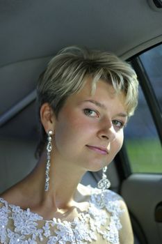 Portrait of the beautiful bride in the car