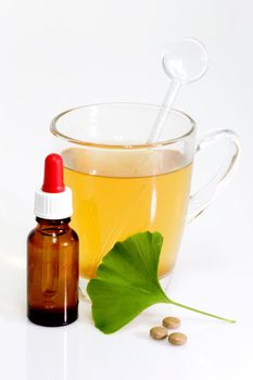 Fresh Ginkgo Biloba leaf with a glass of tea.