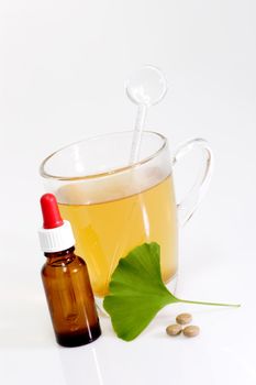 Fresh Ginkgo Biloba leaf with a glass of tea.