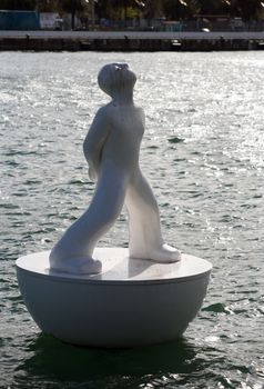 White buoy shaped like a man in Port Vell, Barcelona