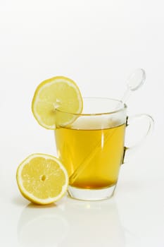 Glass of lemon tea on bright background