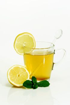 Glass of hot tea with Lemon on bright background