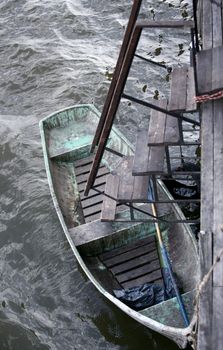 Rowing a boat in water and an iron ladder