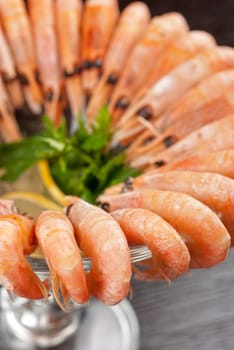 tasty shrimps with lemon and greens closeup