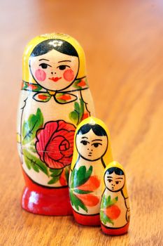 Generic russian nested dolls matrioshka with flowers painted on them on wood table