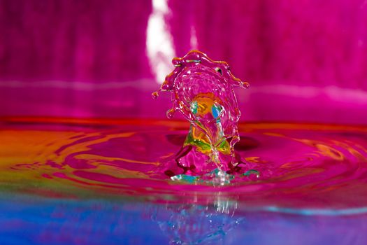 Macro photography of colorful water drop collision sculpture.