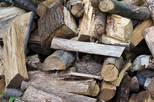 Uncut firewood in an unorganized pile.