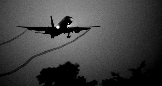 Creative Silhouette of the big plane landing.