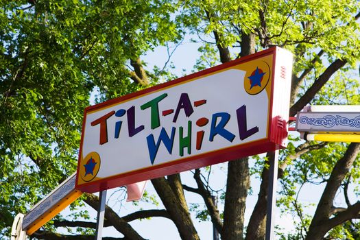 Colorful Tilt a whirl Sign at the amusement park.