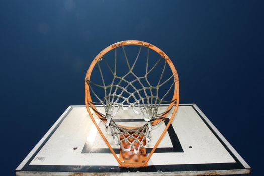 basketball basket against blue sky on a sunny day