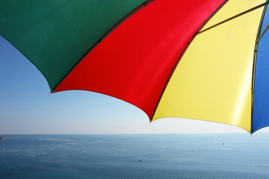 colorful parasol at the ocean on a sunny day