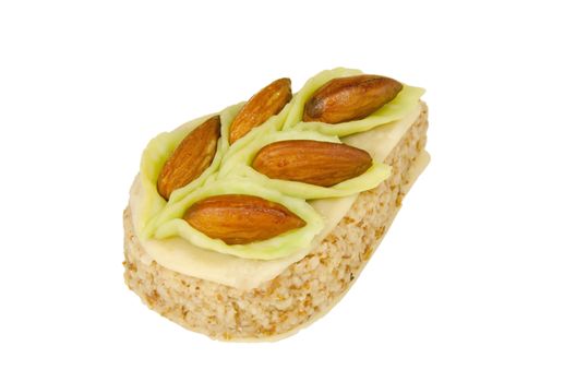 pastry ornamented with almonds isolated on a white background