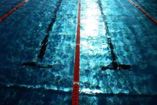 Swimmer in a swimming pool on a hot day