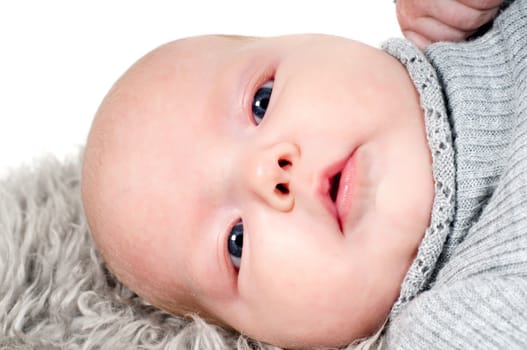 Shot of little cute baby in lying on fur