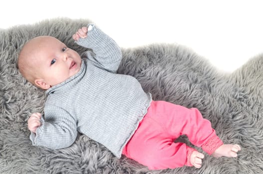 Shot of little cute baby in lying on fur